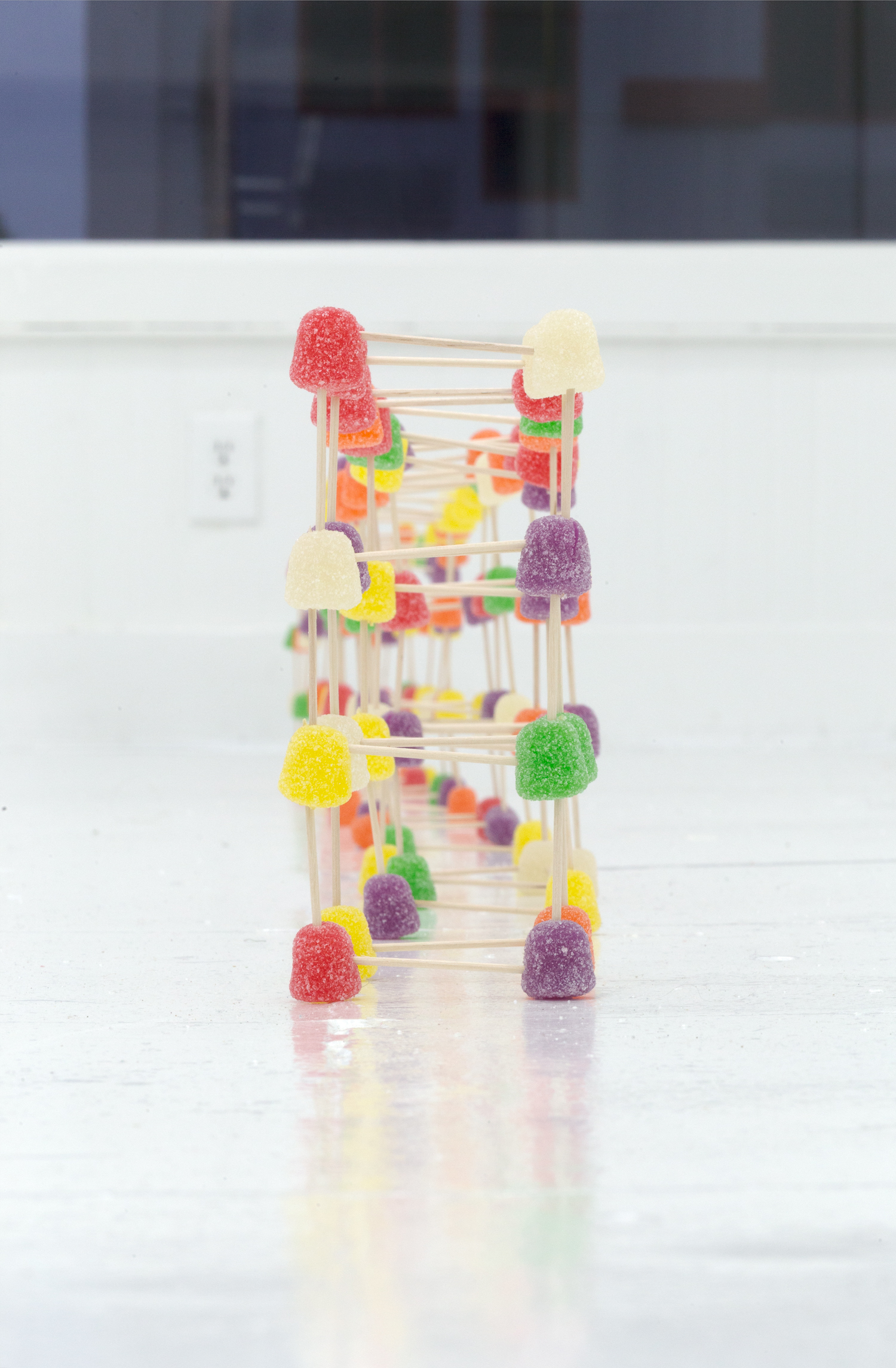 Close up of floor sculpture made of multi-colored candy and toothpicks