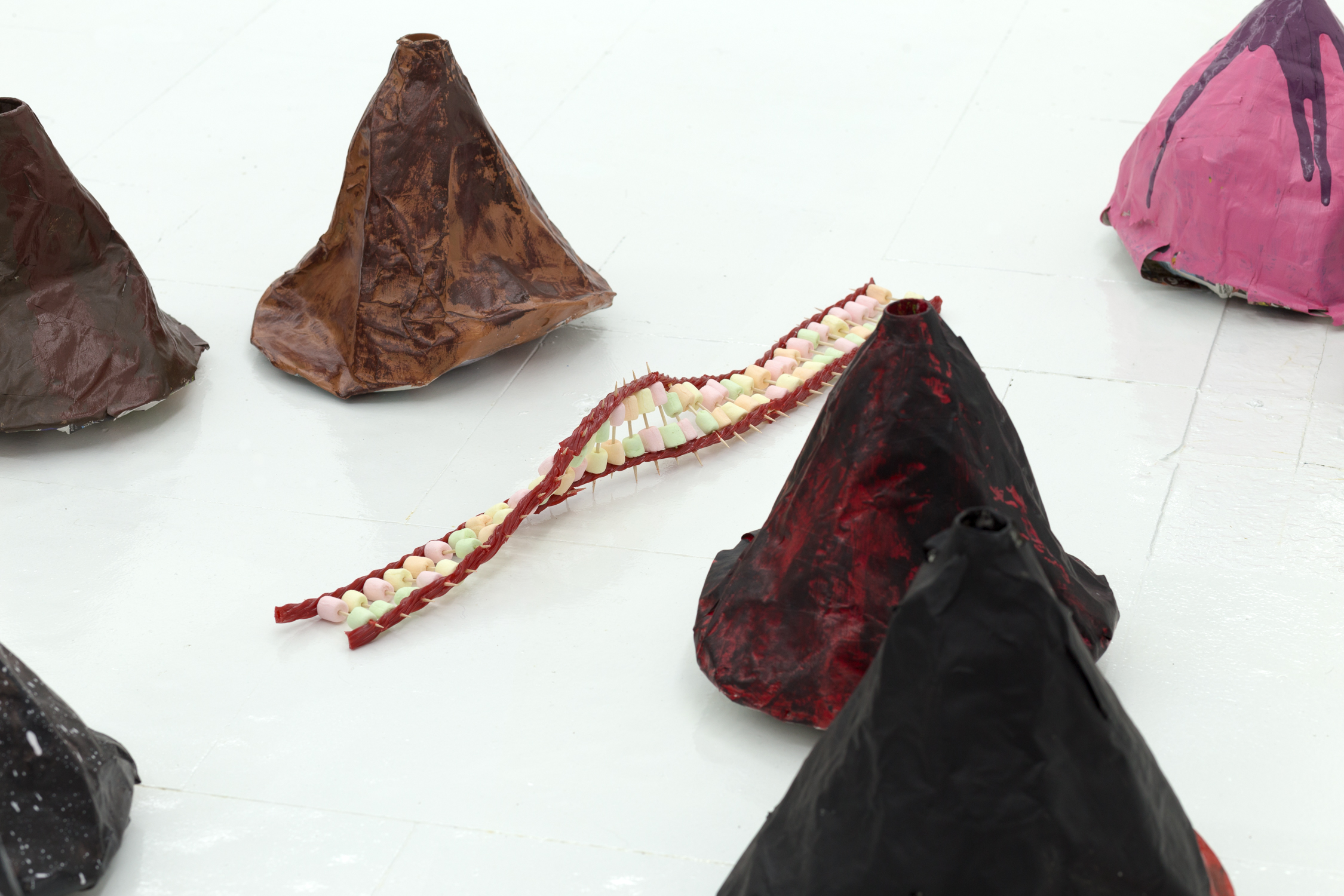 Close up of twisted candy and toothpick sculpture among volcanoes