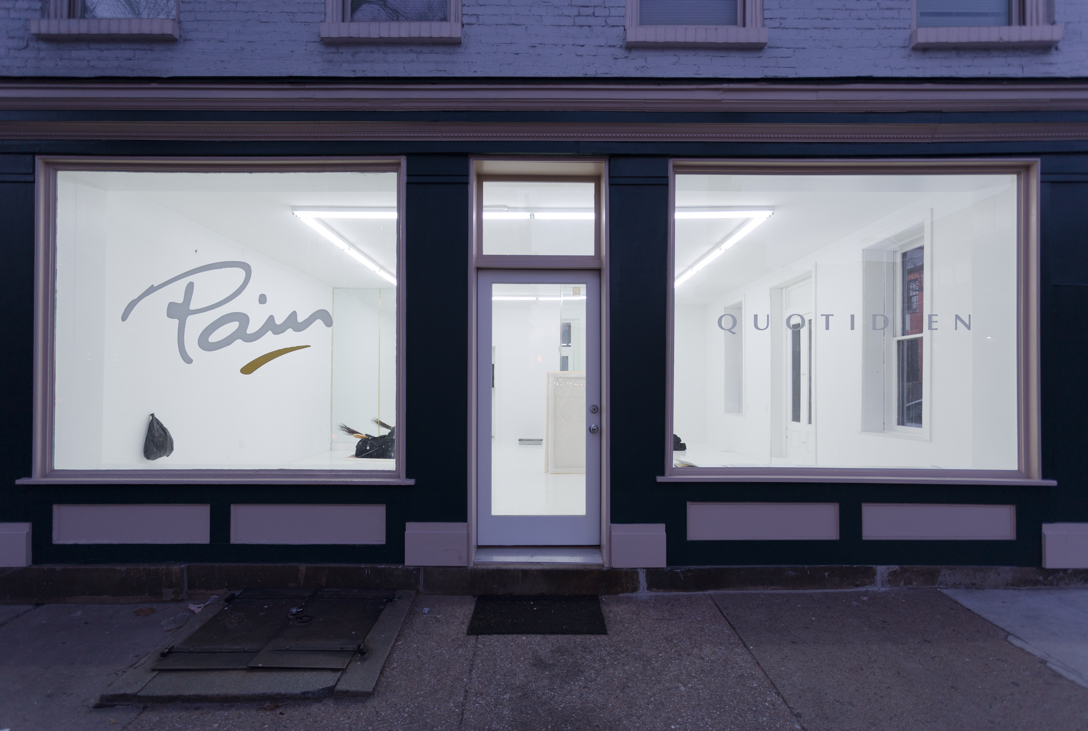 The gallery at dusk, with ‘Pain Quotidien’ decals in the front windows