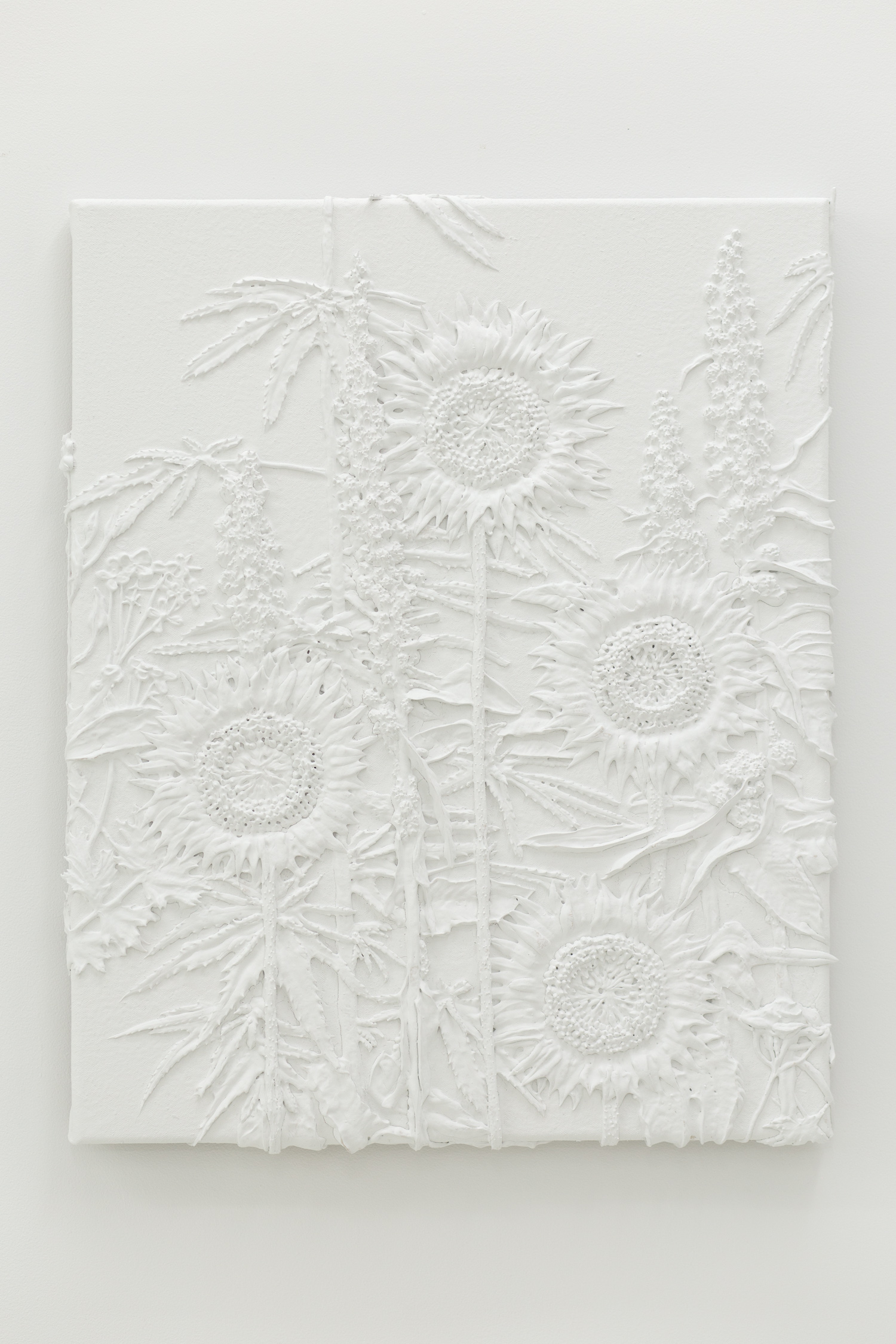 White monotone plastic painting of four sunflowers and assorted other plants
