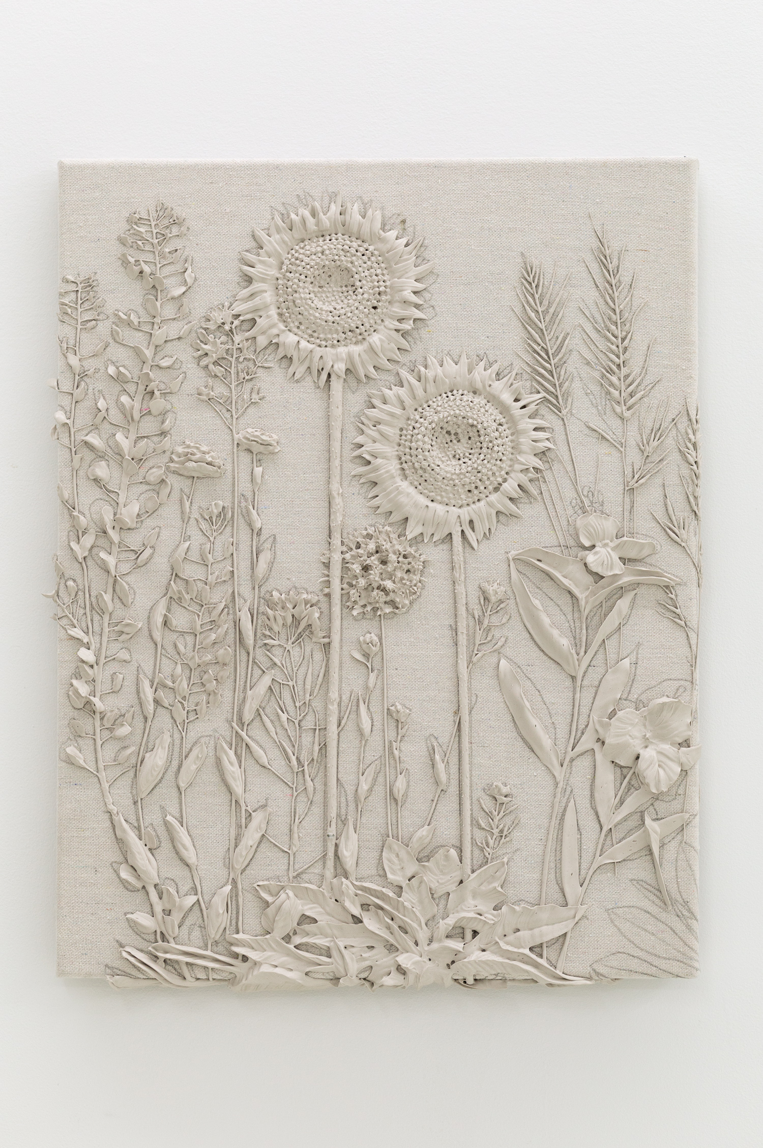 Tan monotone plastic painting of two sunflowers and assorted other plants