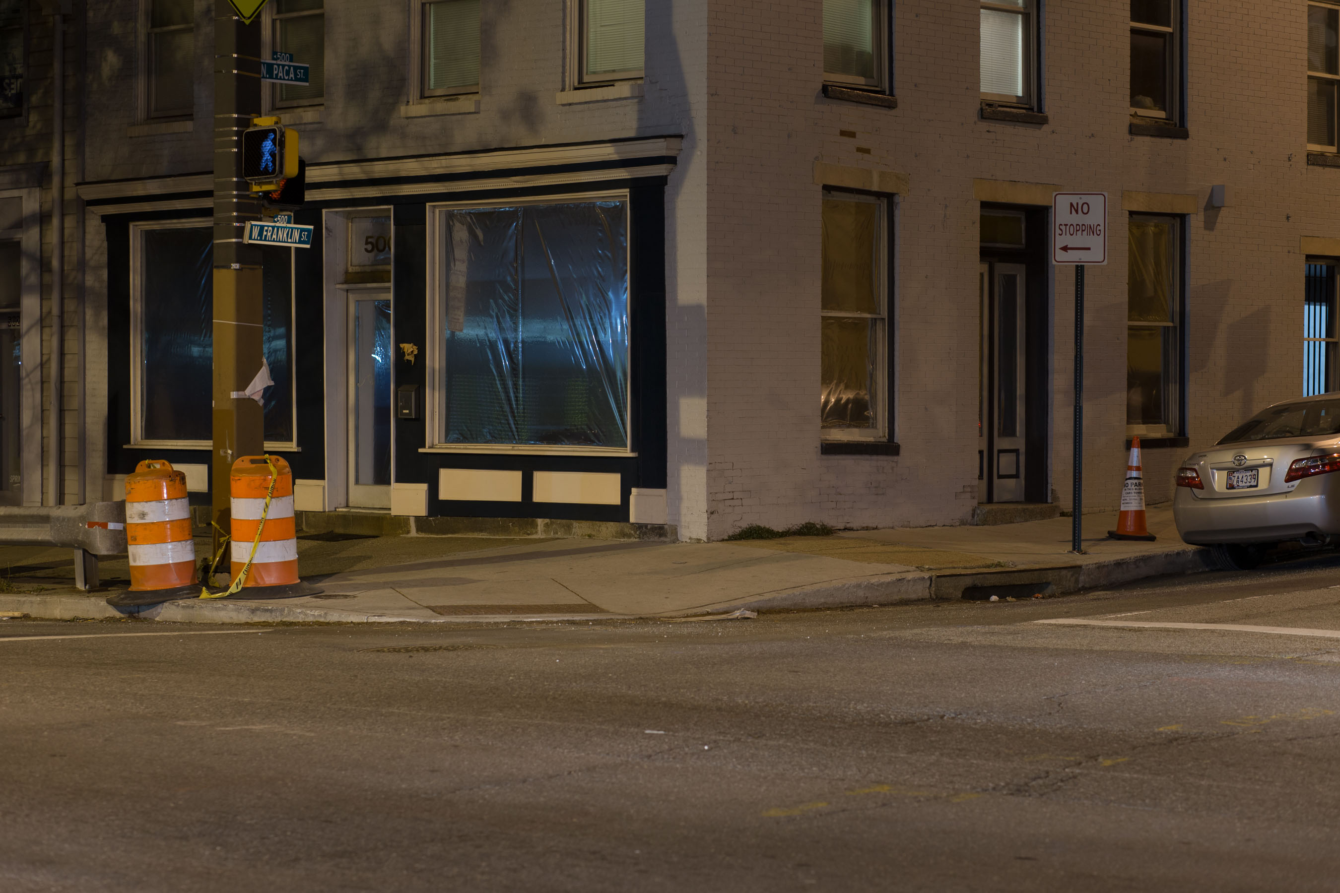 View of the gallery at night from across the street; the windows are covered in reflective mylar