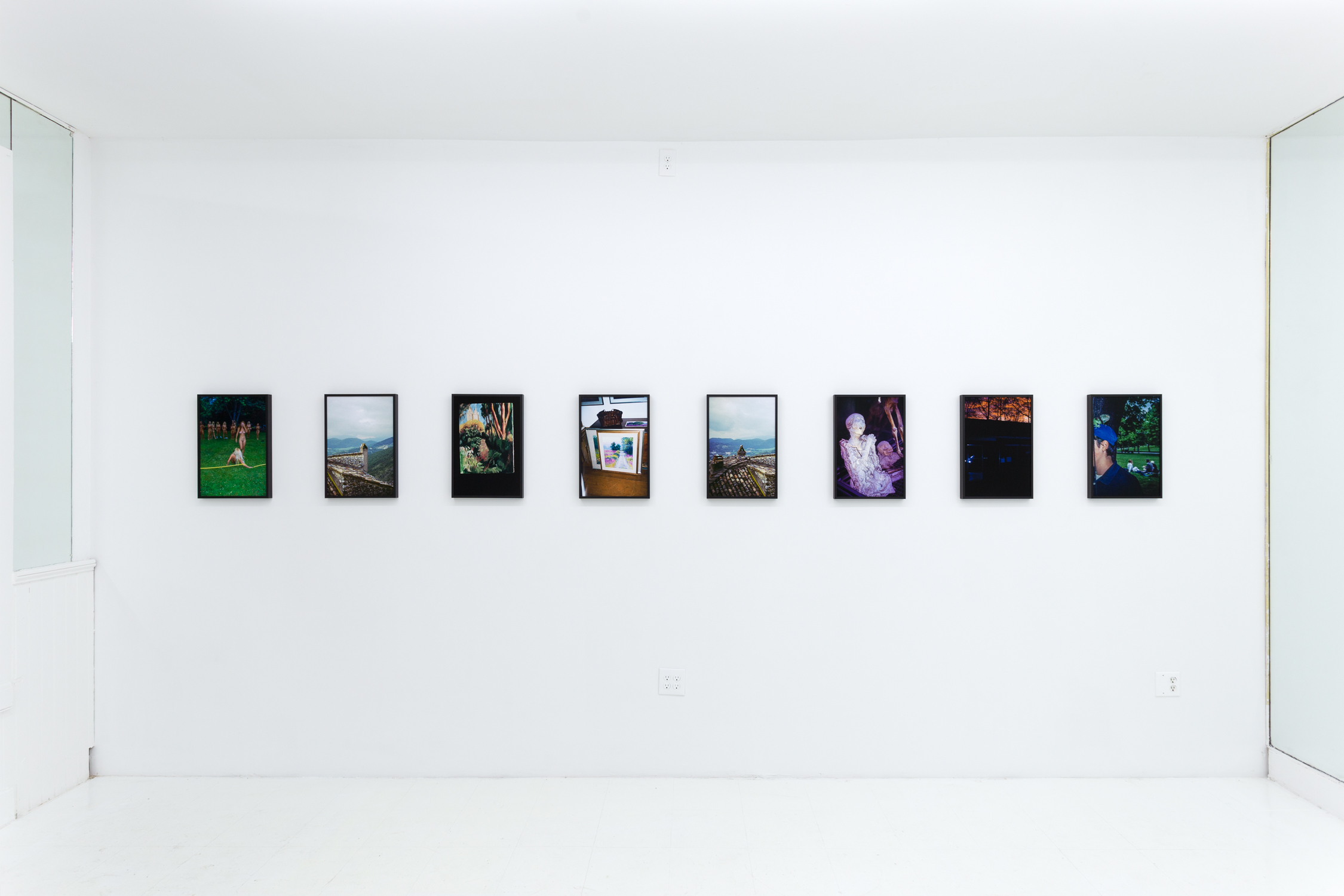 A collection of eight photos on the wall